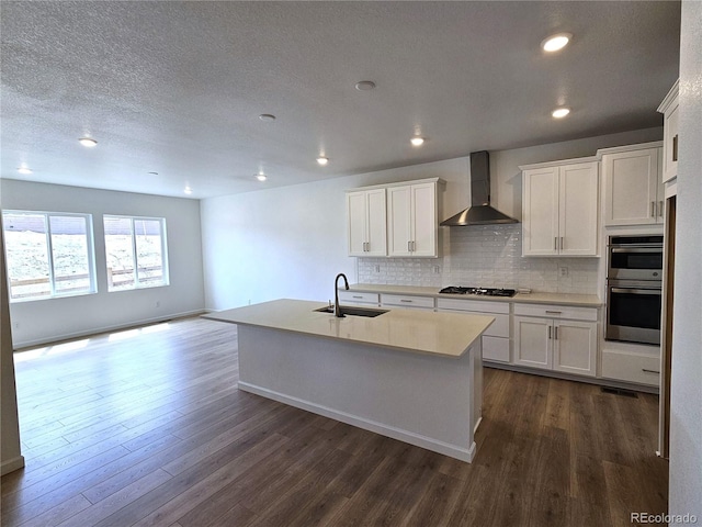 17146 W 92nd Loop, Arvada, CO 80007 - kitchen featuring wall chimney exhaust hood, a sink, gas stovetop, double oven, and dark wood-style flooring