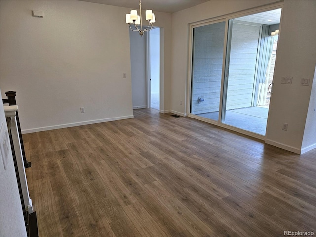 17146 W 92nd Loop, Arvada, CO 80007 - unfurnished room featuring a chandelier, dark wood-type flooring, and baseboards