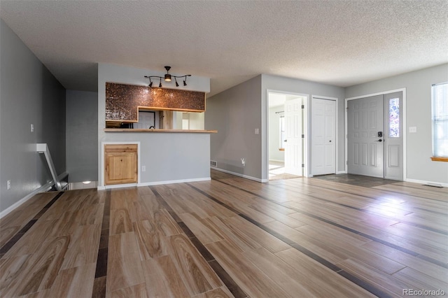 interior space with hardwood / wood-style flooring and a textured ceiling