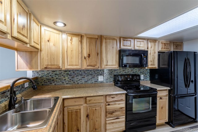 kitchen with light brown cabinetry, decorative backsplash, sink, and black appliances