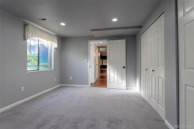 unfurnished bedroom with carpet floors and a closet