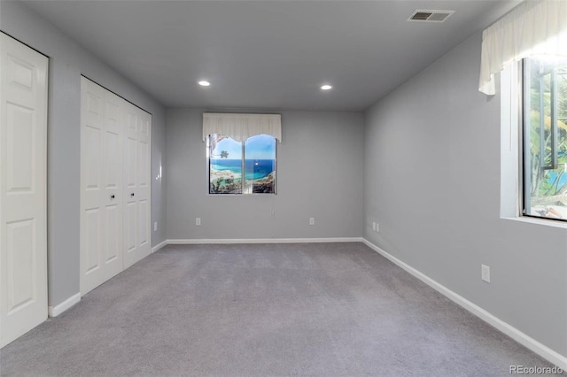 unfurnished bedroom featuring light colored carpet