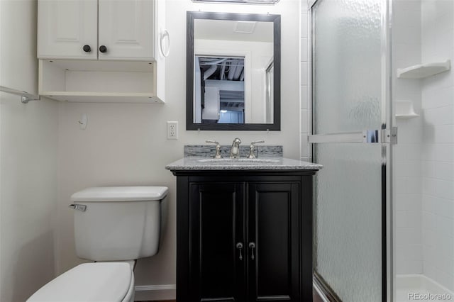 bathroom with toilet, vanity, and an enclosed shower