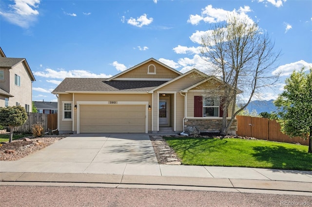 view of front of home featuring an attached garage, driveway, and a shingled roof