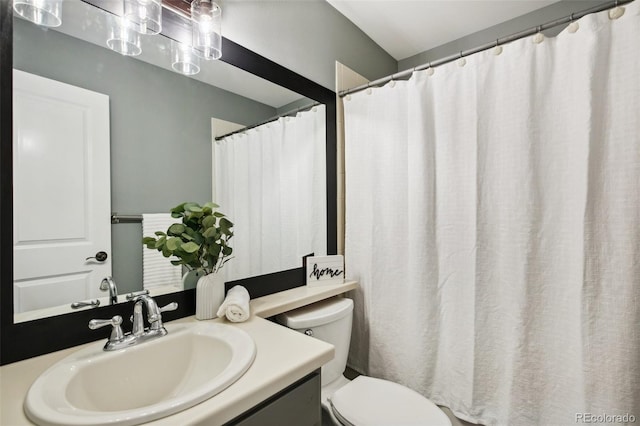full bathroom with toilet and vanity