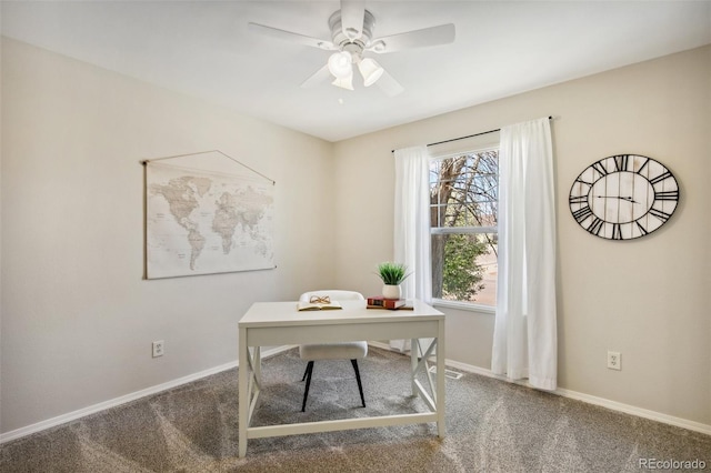 office area with carpet floors, a ceiling fan, and baseboards