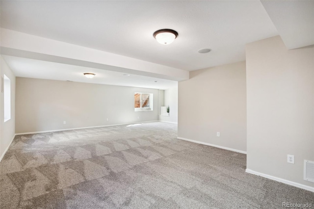 carpeted empty room with baseboards