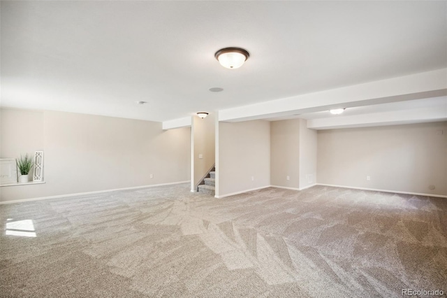 finished basement featuring stairway, carpet flooring, and baseboards