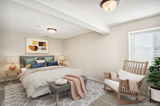 bedroom featuring baseboards, carpet floors, and beam ceiling
