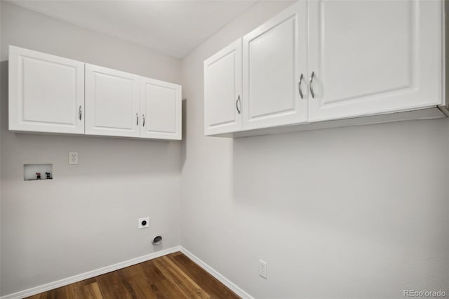 clothes washing area featuring cabinet space, hookup for a washing machine, dark wood finished floors, baseboards, and electric dryer hookup