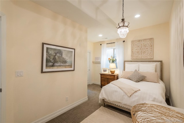 carpeted bedroom with a chandelier