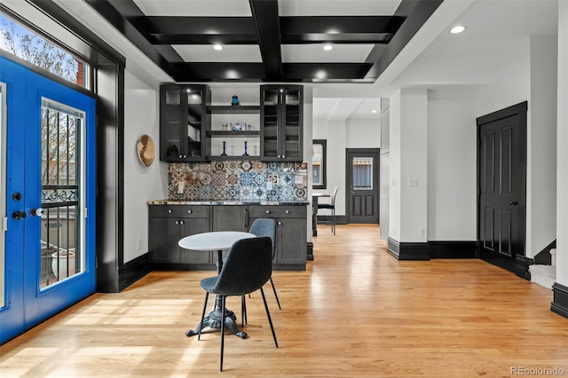 kitchen featuring tasteful backsplash, baseboards, open shelves, light wood-style floors, and beamed ceiling