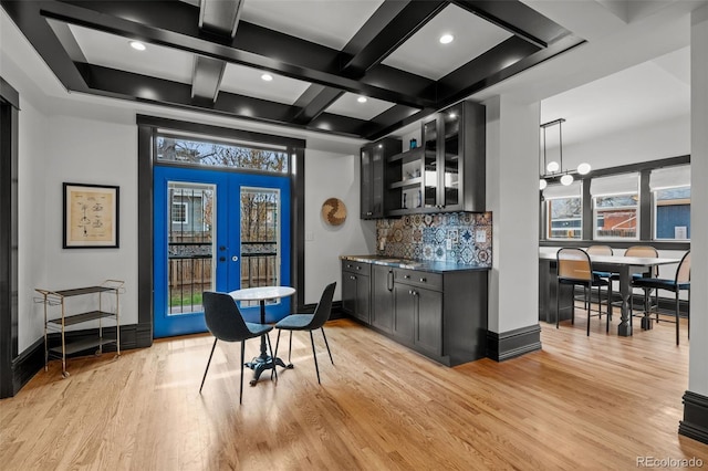 bar with light wood-type flooring, french doors, beam ceiling, coffered ceiling, and decorative backsplash