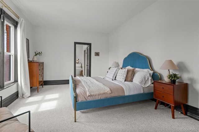 bedroom with baseboards and carpet floors