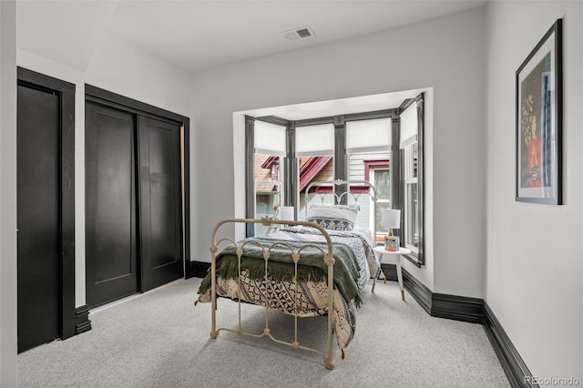 bedroom with visible vents, baseboards, and carpet flooring