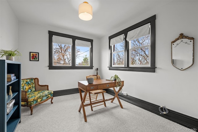 carpeted office featuring baseboards