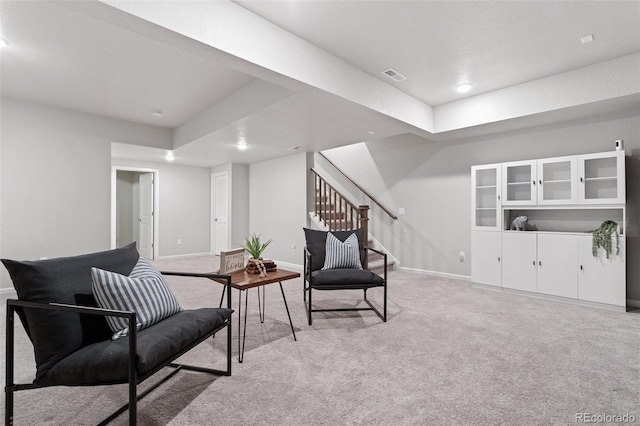 living area featuring light colored carpet