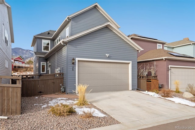 front of property with a mountain view and a garage