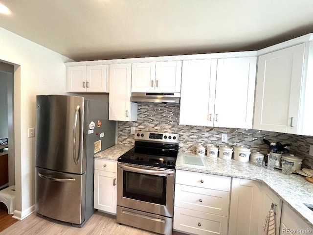 2285 S Knox Ct, Denver, CO 80219 - kitchen with stainless steel appliances, under cabinet range hood, light wood-style flooring, tasteful backsplash, and white cabinetry
