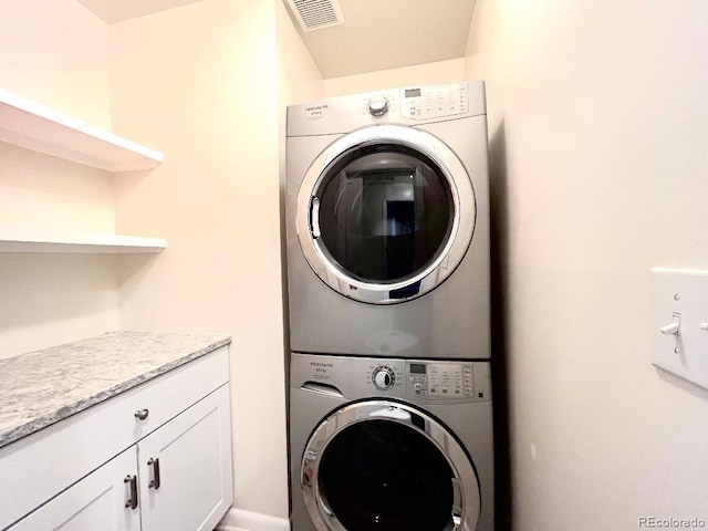 2285 S Knox Ct, Denver, CO 80219 - washroom with stacked washer / drying machine and cabinet space