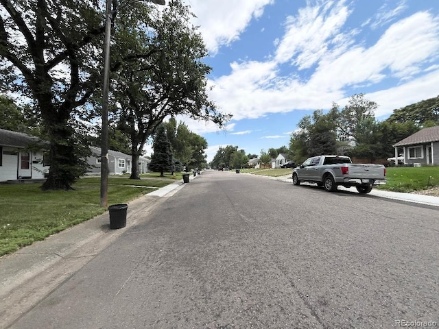 2285 S Knox Ct, Denver, CO 80219 - view of asphalt road featuring sidewalks, curbs, and a residential view