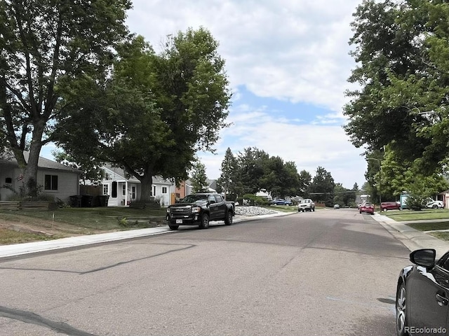 2285 S Knox Ct, Denver, CO 80219 - view of asphalt street featuring curbs, sidewalks, and a residential view