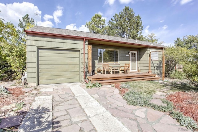 ranch-style home featuring a garage and a wooden deck