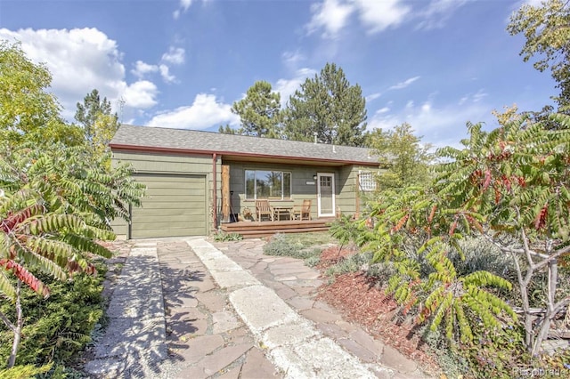 view of front of property featuring a deck and a garage