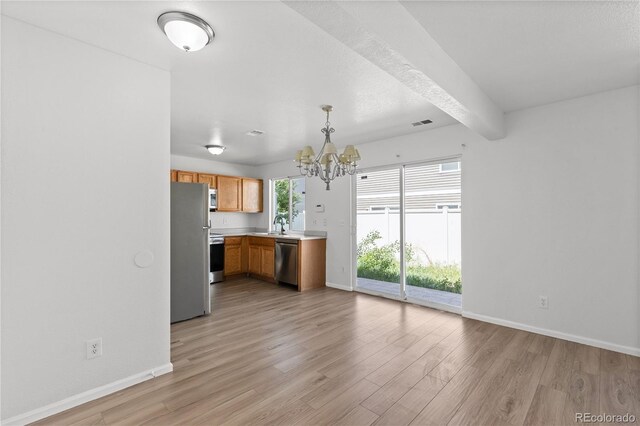 19817 E 47th Pl, Denver, CO 80249 - kitchen with stainless steel appliances, a chandelier, light wood-style floors, baseboards, and beamed ceiling