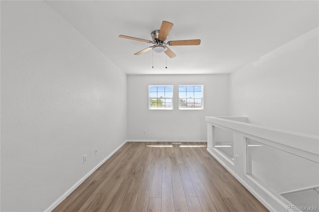 19817 E 47th Pl, Denver, CO 80249 - unfurnished room featuring wood finished floors, a ceiling fan, and baseboards