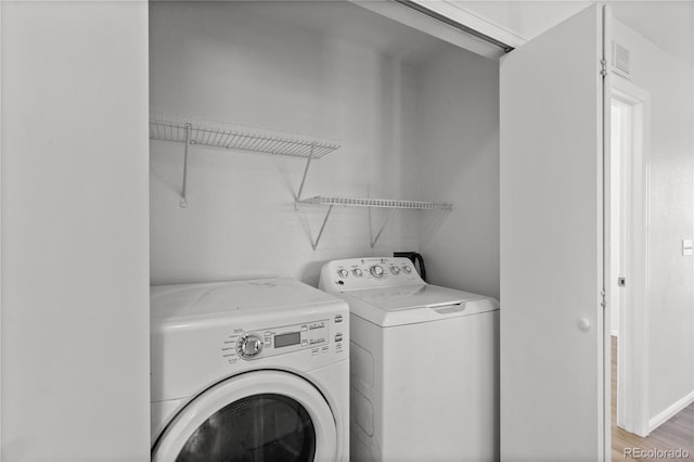 19817 E 47th Pl, Denver, CO 80249 - laundry area with washing machine and dryer and light wood-style floors