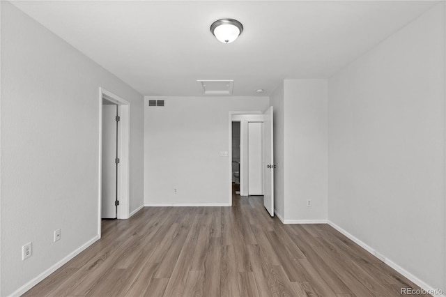 19817 E 47th Pl, Denver, CO 80249 - empty room featuring attic access, wood finished floors, and baseboards