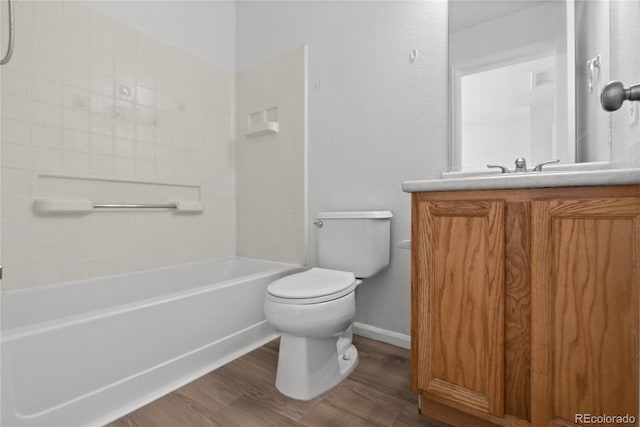 19817 E 47th Pl, Denver, CO 80249 - full bath featuring wood finished floors, toilet, vanity, baseboards, and bathtub / shower combination