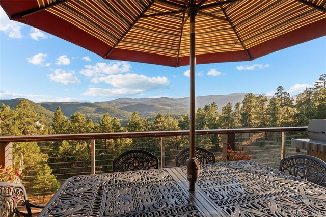 balcony with a view of trees and a mountain view