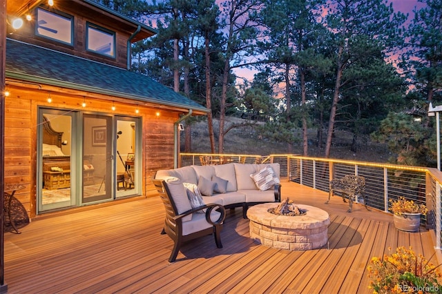 deck featuring an outdoor living space with a fire pit