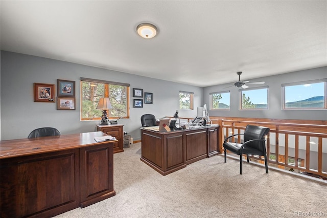home office featuring a ceiling fan and light colored carpet