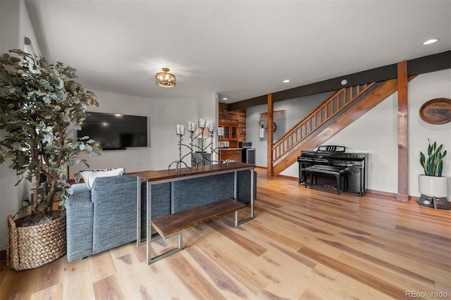 living room with recessed lighting, baseboards, wood finished floors, and stairway