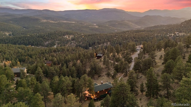 birds eye view of property with a mountain view and a forest view