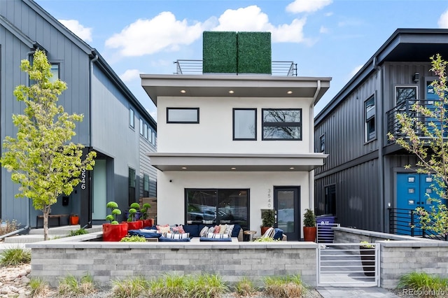 rear view of property with stucco siding