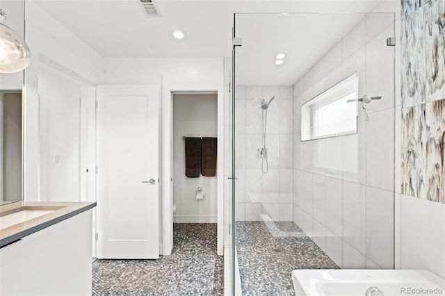 full bathroom featuring a stall shower, vanity, toilet, visible vents, and recessed lighting