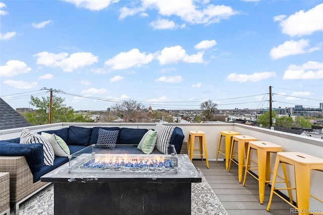 deck with an outdoor living space with a fire pit