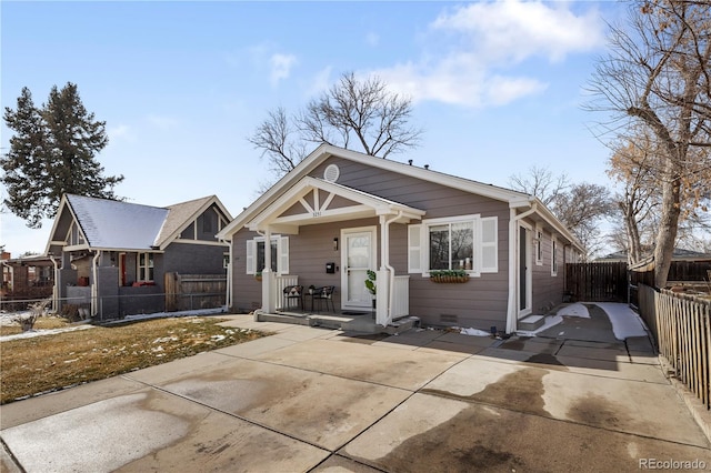 view of front of house with a porch and fence