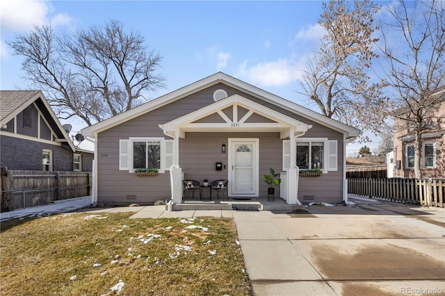 bungalow featuring a porch, fence, and crawl space