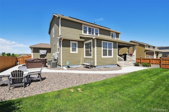 16188 Elizabeth St, Thornton, CO 80602 - back of house with a fenced backyard, a hot tub, and a patio