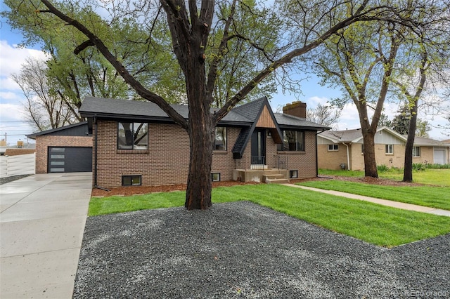 4580 Garland St, Wheat Ridge, CO 80033 - view of front of house with brick siding, a front lawn, a garage, concrete driveway, and a chimney