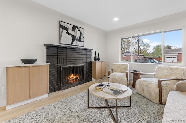 4580 Garland St, Wheat Ridge, CO 80033 - living room featuring a brick fireplace, light wood finished floors, and recessed lighting
