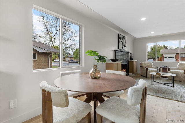 4580 Garland St, Wheat Ridge, CO 80033 - dining space with healthy amount of natural light, recessed lighting, light wood-style flooring, baseboards, and a warm lit fireplace