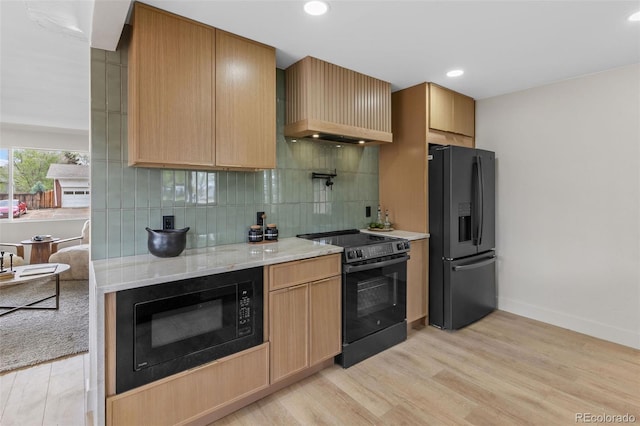 4580 Garland St, Wheat Ridge, CO 80033 - kitchen featuring black appliances, custom exhaust hood, light wood-style flooring, decorative backsplash, and recessed lighting