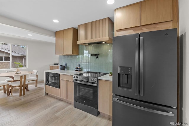 4580 Garland St, Wheat Ridge, CO 80033 - kitchen with stainless steel refrigerator with ice dispenser, range with electric cooktop, custom exhaust hood, black microwave, and light brown cabinets