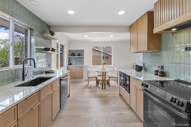 4580 Garland St, Wheat Ridge, CO 80033 - kitchen featuring black appliances, a sink, custom exhaust hood, light stone counters, and backsplash